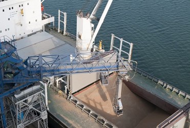Grain being loaded onto a cargo boat